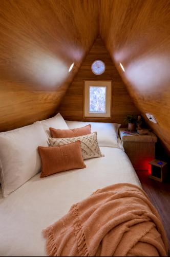 a bedroom with a large bed in a attic at Kangaroo Island A-Frame Off-Grid Escape in Pelican Lagoon