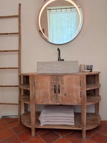 a bathroom vanity with a sink and a mirror at Clos Lujatis in Valençay