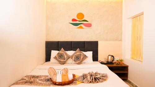 a bedroom with a bed with shoes on it at River Town Stays in Varanasi