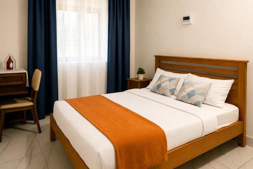 a bedroom with a bed and a desk and a window at Gracious Haven - Fully Equipped Rooftop with private terrace house in Saint-Pierre, Moka in Moka