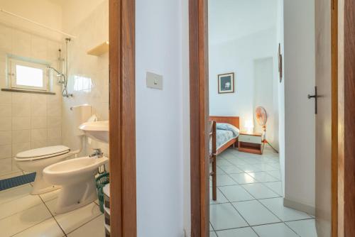 a bathroom with a toilet and a sink at Acqua e Sale in Pomonte