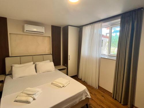 a bedroom with a bed with two towels on it at Mudanya Yıldız Otel in Mudanya