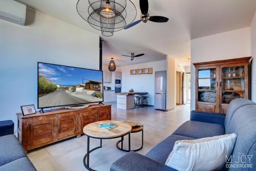 a living room with a large flat screen tv at PAPANG - House 148m 3rooms Jacuzzi in Saint-Leu
