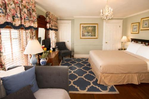 a hotel room with a bed and a couch at Inn on Bellevue in Newport