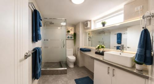 a bathroom with a sink and a toilet at Sea Breeze Apartment in Mandurah