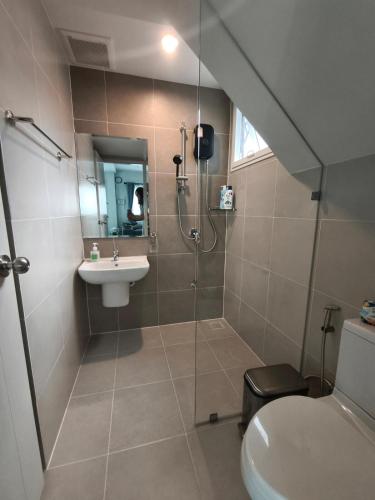 a bathroom with a shower and a toilet and a sink at Silbergluuk in Udon Thani