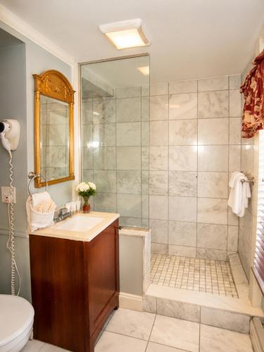 a bathroom with a shower and a sink at Inn on Bellevue in Newport