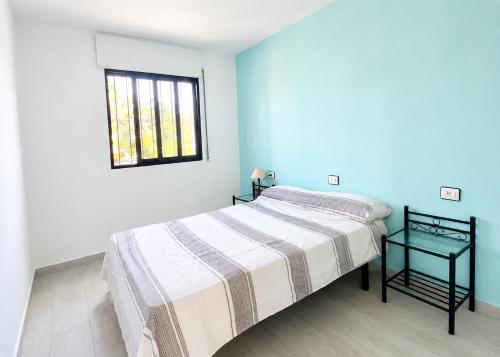 a white bedroom with a bed and a window at Turyva Tarongers 1 - Modern 1-Bedroom Apartment Near the Beach, Costa del Azahar in Peniscola
