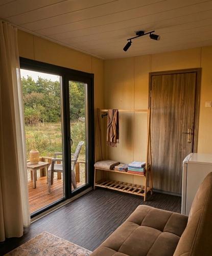 a living room with a couch and a sliding glass door at Enjoy the Silence in Marmaris