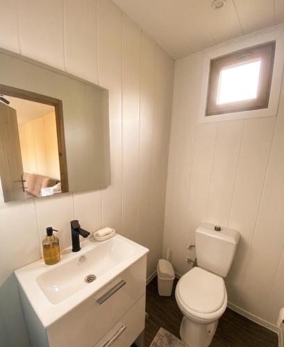 a bathroom with a white toilet and a sink at Enjoy the Silence in Marmaris