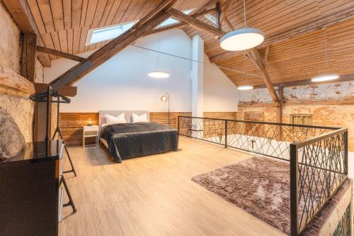 a loft bedroom with a bed and a balcony at Ferienhaus Rabenbrunn in Arnstorf