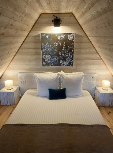 a bedroom with a large bed with two night stands at Domaine de Meros in Plonévez-du-Faou