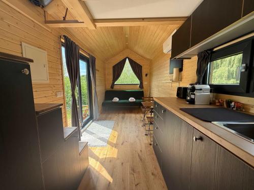 a kitchen in a tiny house with a large window at Ezy House by Tiny Away in Ézy-sur-Eure