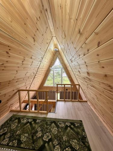 a room with a large window in a wooden room at A-Frame House Tosor in Tossor