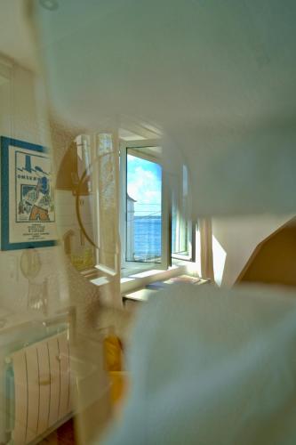 a view of a room with a view of the ocean at La Villa des Sables in Concarneau