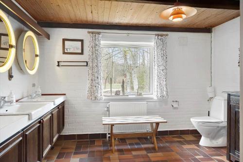 a bathroom with a sink and a toilet and a window at 591-Snedsted-Stenbjergvej-28 in Snedsted