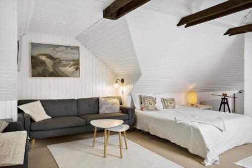 a living room with a bed and a couch at 591-Snedsted-Stenbjergvej-28 in Snedsted