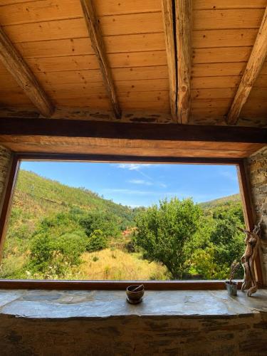 a window in a room with a view of a mountain at Quinta WOW in Benfeita