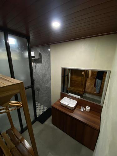 a bathroom with a sink and a mirror at Han's Villa in Sumbawa Besar