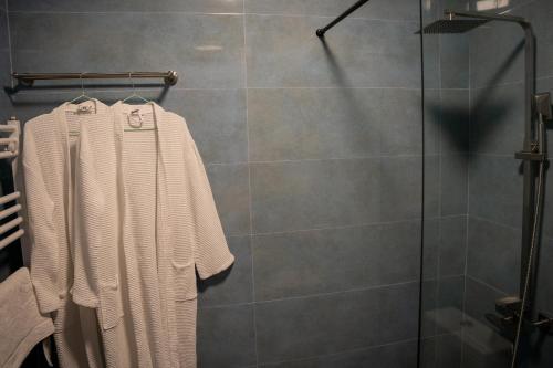 a bathroom with a shower with a white towel at Kazbegi Hotel Grand View in Kazbegi
