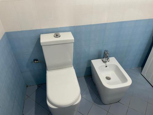 a bathroom with a toilet and a sink at Olive in Tirana