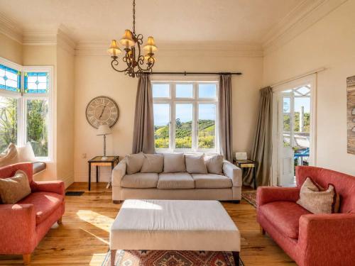 a living room with a couch and two chairs at Crescent Villa - Stay Waiheke in Ostend