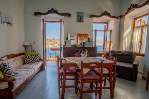 a living room with a table and a couch at Villa Pitini in Symi