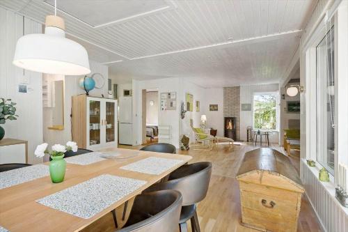 a dining room with a table and leather chairs at 8229-Lundby-Stenurtvej-6 in Lundby