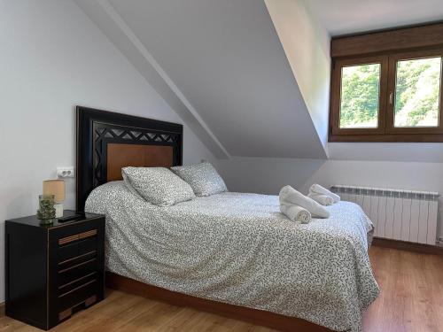 a bedroom with a bed with two pillows on it at El Rincon de Carmen in Felechosa
