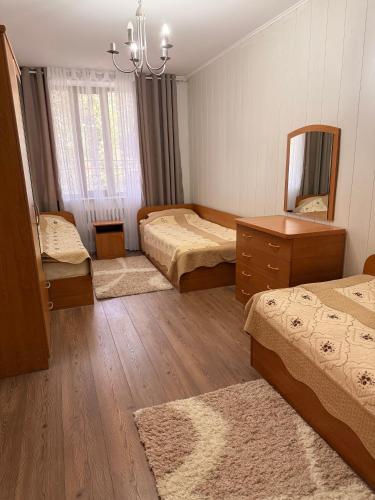 a hotel room with two beds and a mirror at Солнышко VIP 1 in Chok-Tal