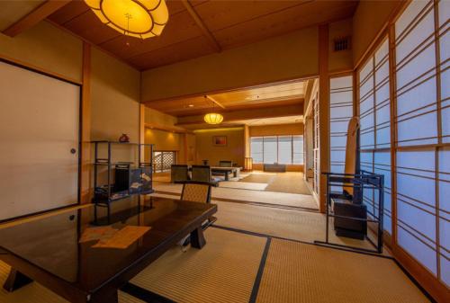 a room with a table and chairs in a building at Zazan minakami in Minakami