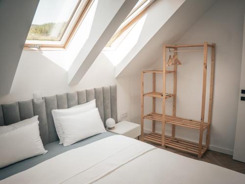 a bedroom with a bed and a window at Miło Tu - Stodoła pod Karpaczem in Miłków