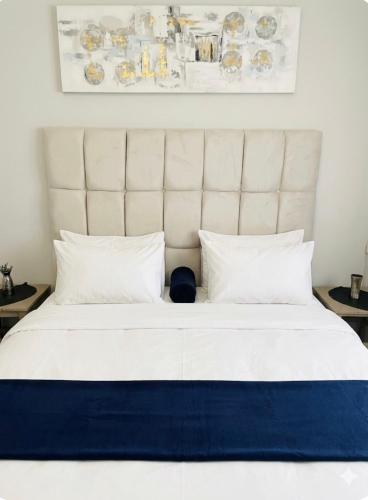 a large white bed with a large white headboard at Maun self-catering unit in Maun