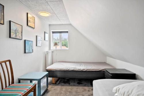 a small room with a bed and a window at 4231-Stege-Nymarksvej-21 in Stege