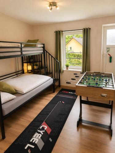 a bedroom with a bed and a foosball table at Ferienhaus im Wiesengrund in Simmerath