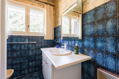 a bathroom with a sink and a mirror at La Villa D'antan - Piscine in Nyons