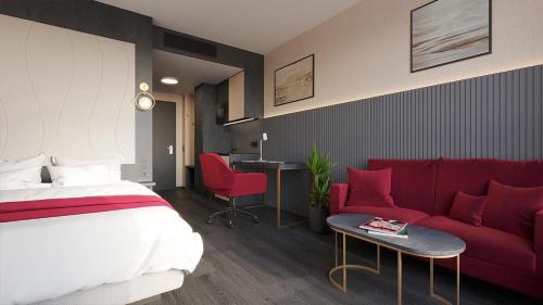 a hotel room with a bed and a red couch at PLAZA Residence Mannheim in Mannheim