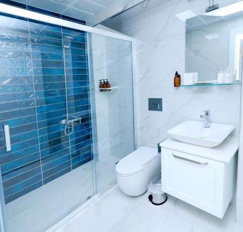 a bathroom with a shower and a toilet and a sink at Felicitta Stay & Joy in Seferihisar
