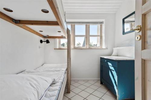 a small room with a bed and a sink at R624-Rodvig-Stevns-Strandvaenget-6 in Rødvig