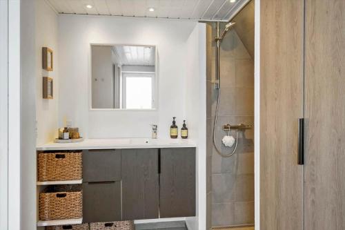 a bathroom with a sink and a shower with a mirror at 1335-Vestervig-Spovevej-11 in Vestervig