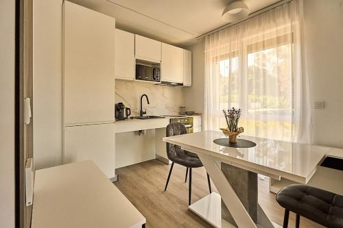 a kitchen with a table and chairs in a room at Magnolia in Alicante