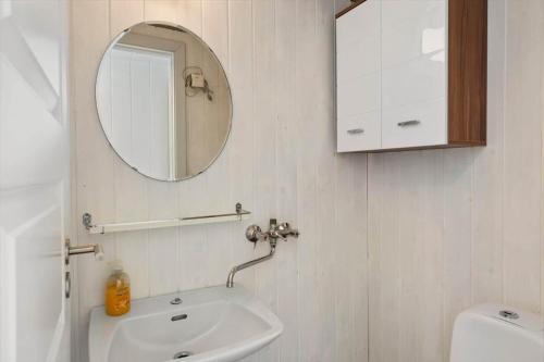 a bathroom with a sink and a mirror and a toilet at 1352-Vestervig-Isfuglevej-19 in Vestervig