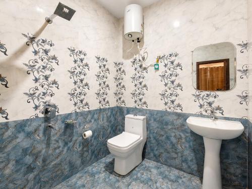 a bathroom with a toilet and a sink at The Sanctuary in McLeod Ganj