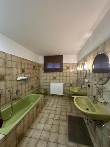 a bathroom with two sinks and a bathtub and a tub and a bath tub at Dream Place in Iserlohn in Iserlohn