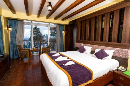 a bedroom with a large bed with purple pillows at Paradise Villa in Kathmandu