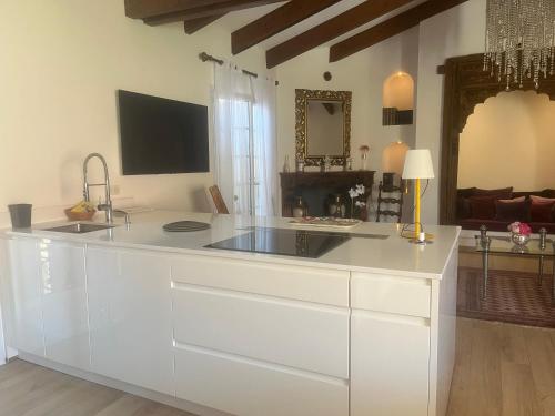 a kitchen with a large white island in a living room at Casa Sultana in Propriano