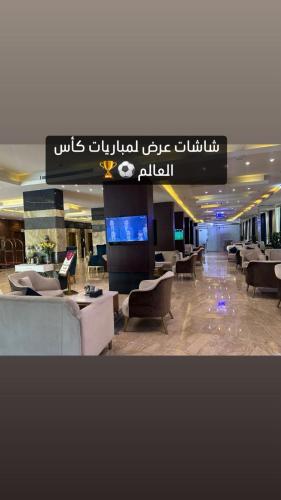 a lobby with couches and chairs in a building at Paradise Inn Jeddah Hotel in Jeddah