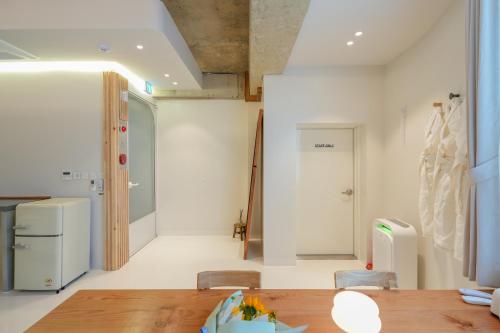 a room with a table and chairs and a refrigerator at 스테이머묾 m2 in Jeonju