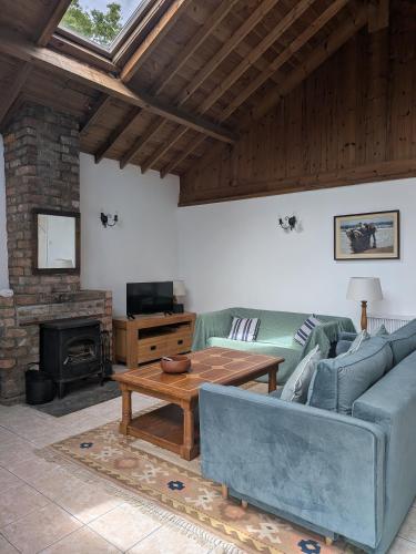 a living room with a blue couch and a table at The Stables in Aglish