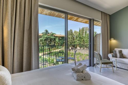 a bedroom with a bed and a large window at Mas Cusi in Palau-Saverdera
